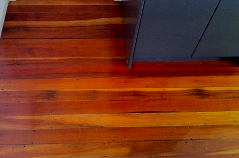 Close-up of rich reddish timber grain with a natural oil finish after floor sanding