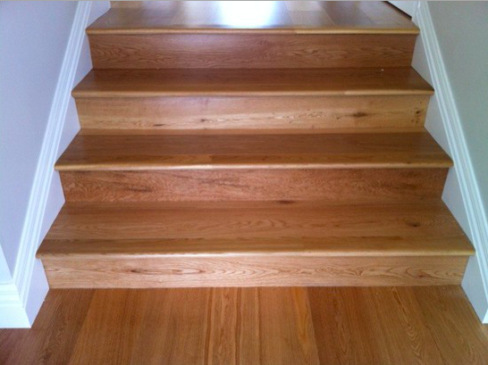 Refinished solid oak stair treads after timber stair sanding in West Auckland